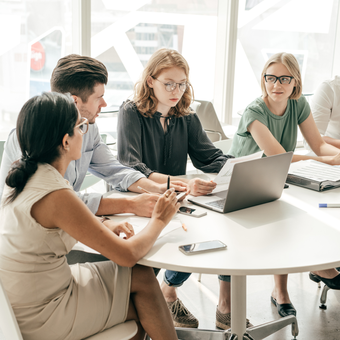 Marketing team in a strategy meeting discussing visibility issues and analyzing why customers can’t find your business online.