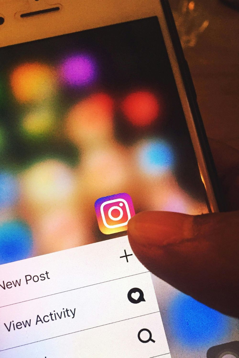 Close-up of a hand opening the Instagram app on a smartphone, showing posting options — Instagram trends for small business 2025