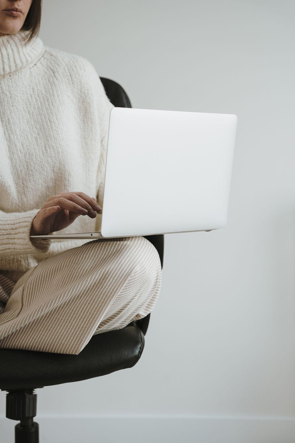 Small business owner working on laptop to manage social media pages