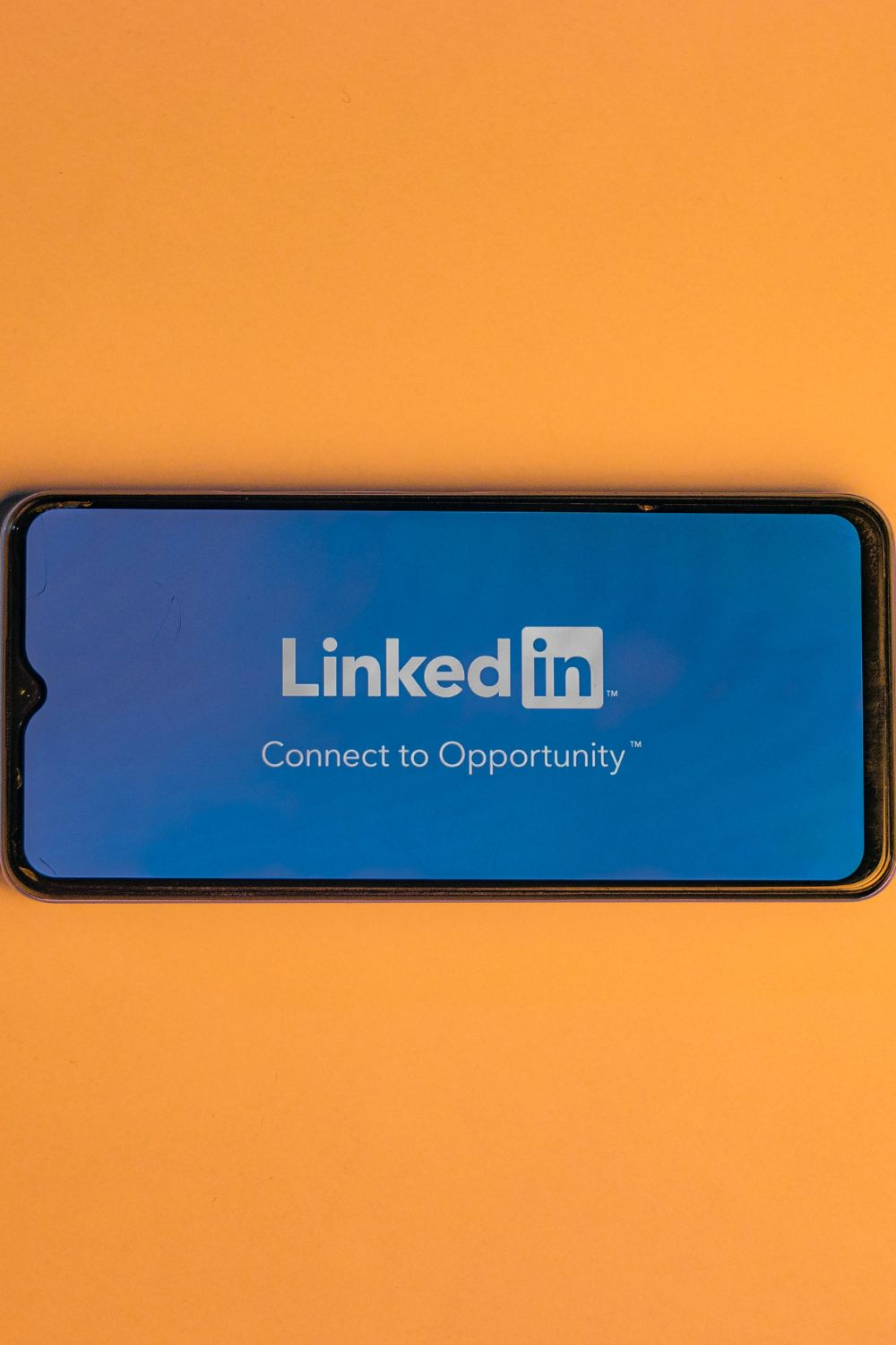 Smartphone screen displaying the LinkedIn logo and tagline, representing LinkedIn social media strategy for business growth.