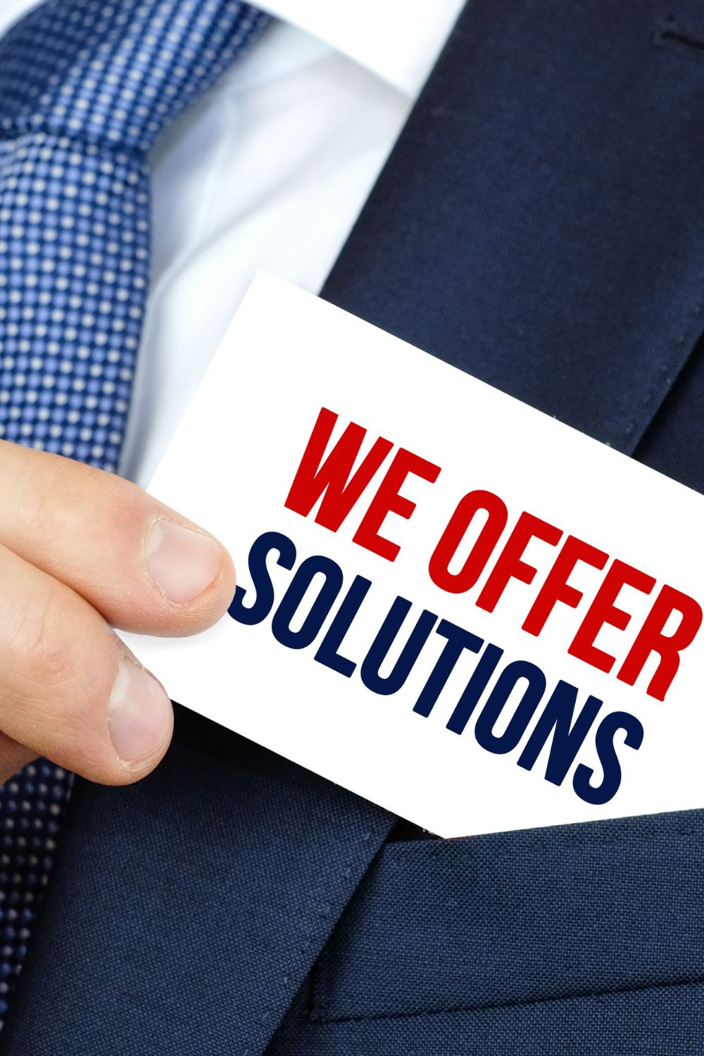 Business professional holding a card that says We Offer Solutions, symbolizing marketing strategies and customer-focused services.
