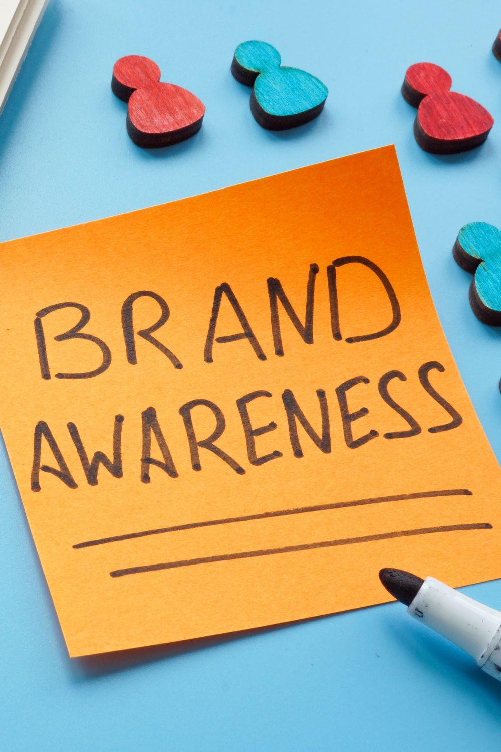 Sticky note with the words “Brand Awareness” written in bold, symbolizing consistent branding and marketing psychology