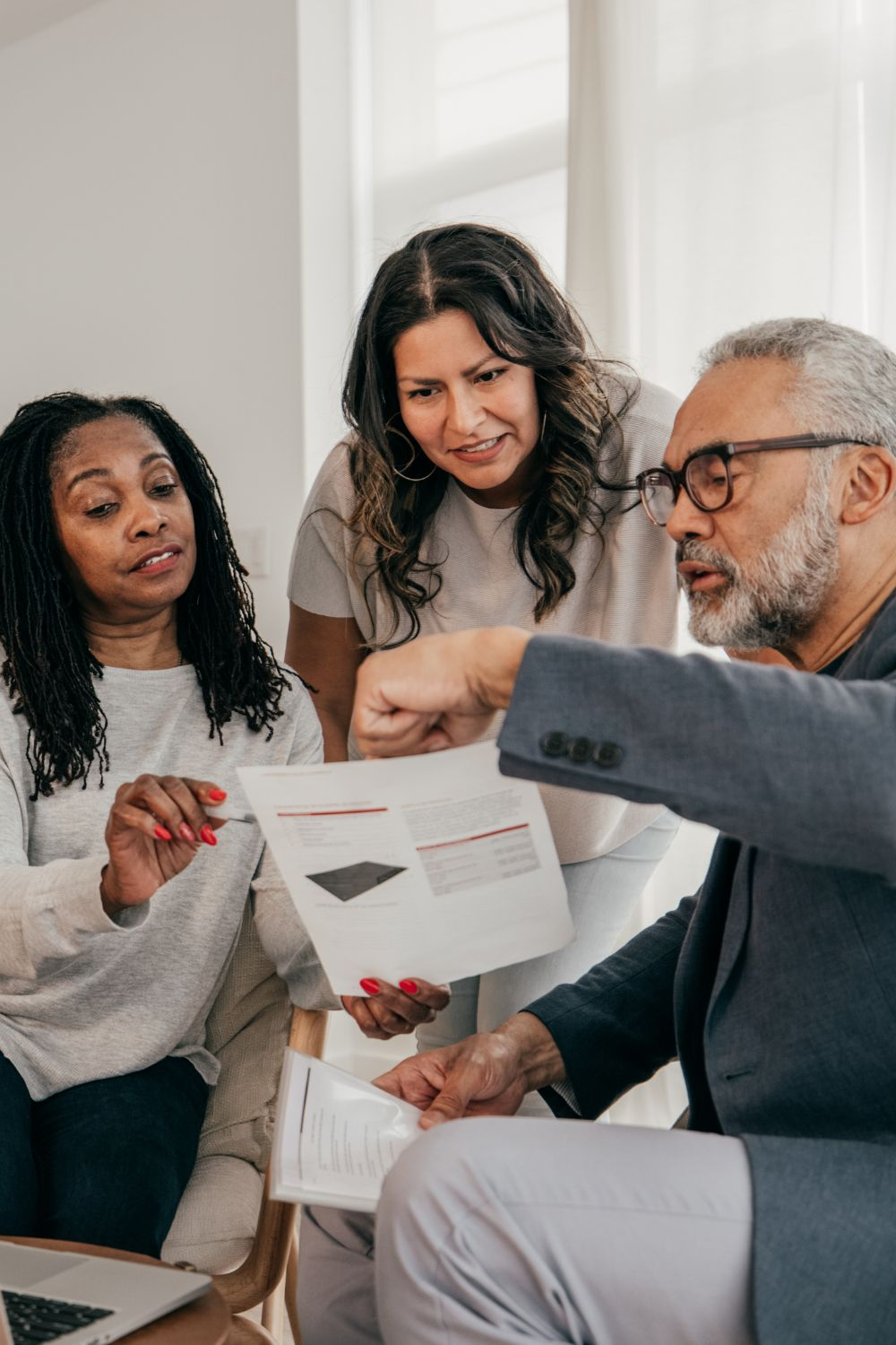 Team of marketing professionals reviewing brand materials to identify and fix inconsistent branding issues.