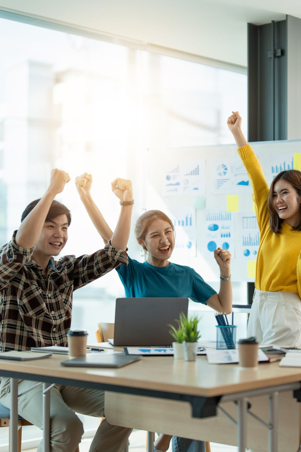 Team celebrating successful social media campaign results in a bright modern office