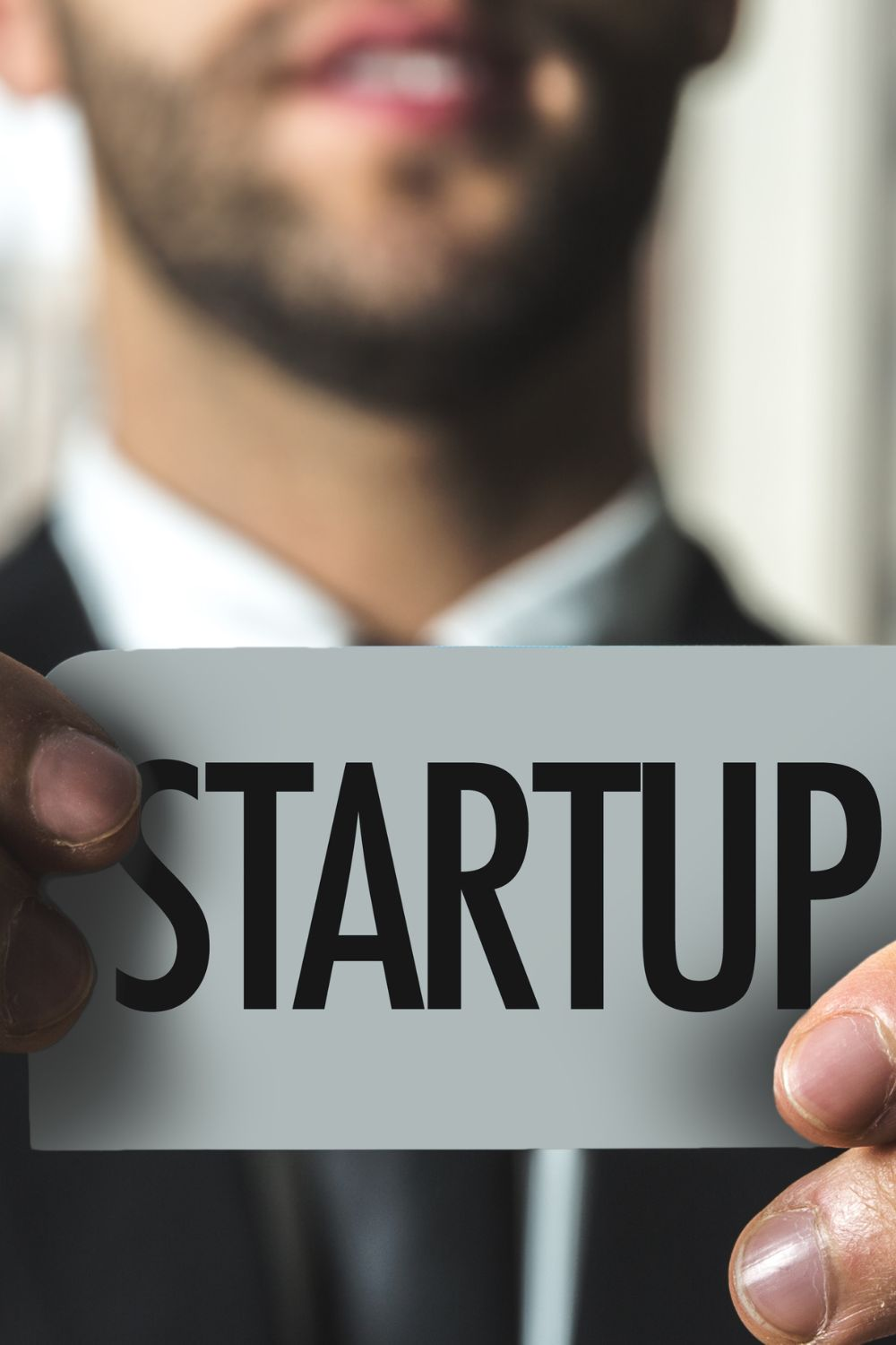 Entrepreneur holding a startup sign representing new social media startups in 2025