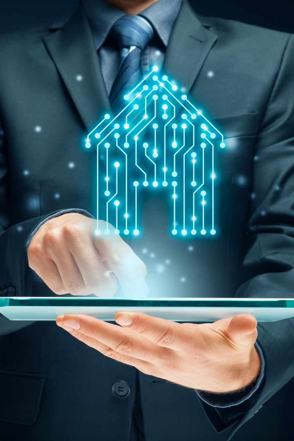 Business professional using a tablet with a glowing digital house icon representing smart technology and innovation