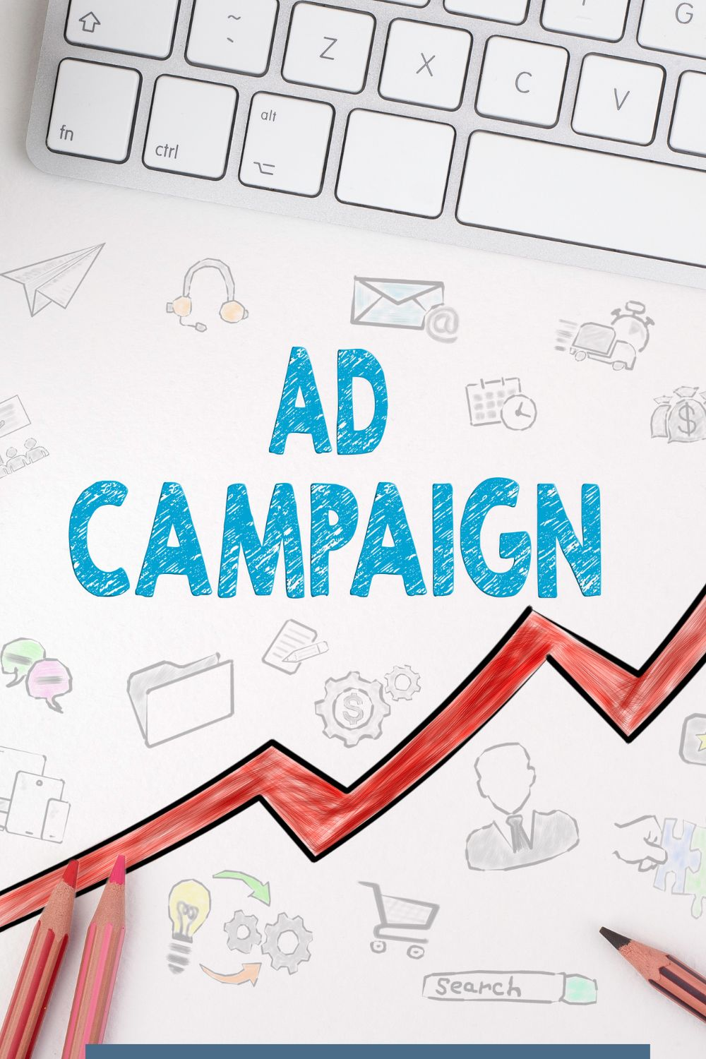 Flat lay of a paper with “Ad Campaign” text, marketing icons, and a red upward arrow beside a keyboard and pencils symbolizing social media growth