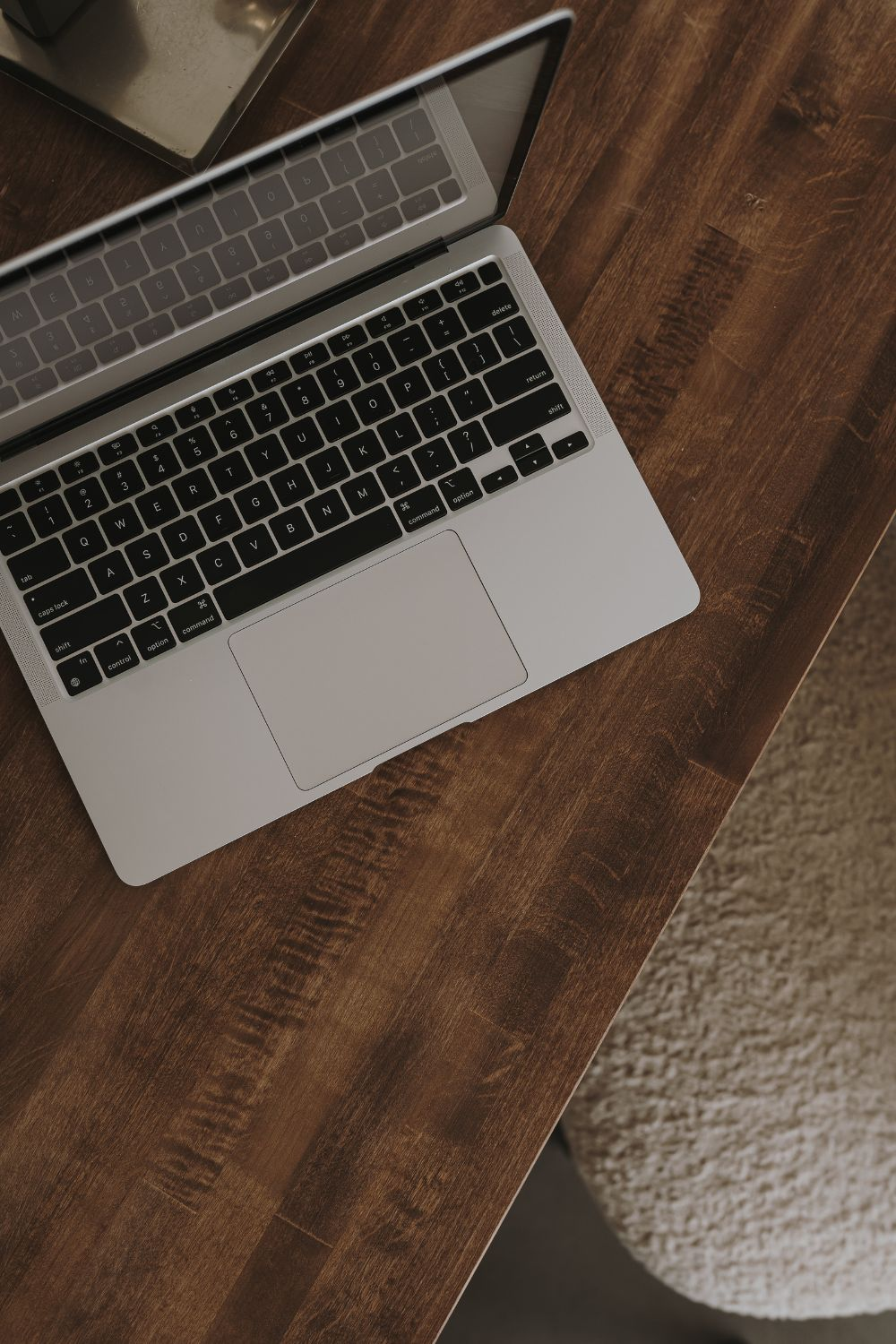Open laptop on a wooden desk, representing social media work or digital marketing planning
